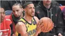  ?? PATRICK T. FALLON / GETTY ?? Former Oshkosh North star Tyrese Haliburton, who plays for the Indiana Pacers, tied an NBA three-point contest record with 31 points in the first round.