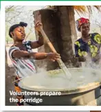  ??  ?? Volunteers prepare the porridge