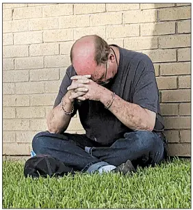 ?? AP/Odessa American/MARK ROGERS ?? A man prays outside a hospital emergency room Saturday in Odessa, Texas, where some of the victims of a shooting rampage were taken.
