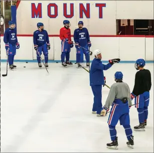 ??  ?? The Mount St. Charles Academy U18 squad noon’s practice at Adelard Arena.
listens
to coach Matt Plante during Monday
after