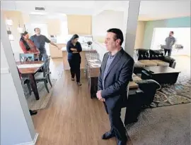  ?? Luis Sinco Los Angeles Times ?? HOOMAN ZAHEDI holds an open house in April at a Canoga Park home listed on Redfin, an online real estate brokerage that pledges to transform home buying.