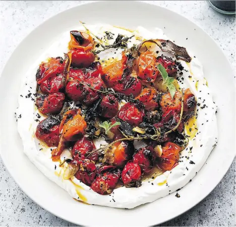  ??  ?? Hot charred cherry tomatoes with cold yogurt, from the cookbook Ottolenghi Simple, are perfectly paired with a glass of B.C. white wine.