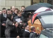  ??  ?? Friends and family, including girlfriend Nollaig Hennessy (centre, holding frame) at the funeral of victim Michael Pyke in Co Tipperary yesterday. Inset below: Mr Pyke. Photo: Provision