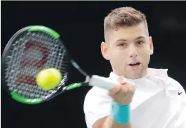  ??  ?? Filip Krajinovic returns the ball during his semifinal match against John Isner at the Paris Masters on Saturday.