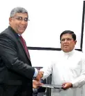  ??  ?? Nandana Ekanayake, CEO of Insee Cement exchanging the MOU and shaking hands with the Minister of Home Affairs Vajira Abeywarden­a