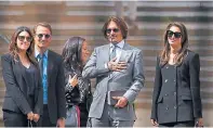  ??  ?? Johnny Depp, centre, leaves the court yesterday