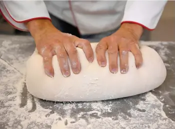  ?? — AFP photos ?? Exner kneads bread dough at his bakery in Beelitz.