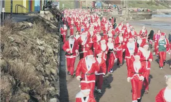  ??  ?? The Santas in action along North Bay during last year’s Santa Dash event