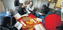  ?? Pictures: Esa Alexander ?? Pete and Sarah Portal interact with a group of young men at their house in Manenberg on the Cape Flats.