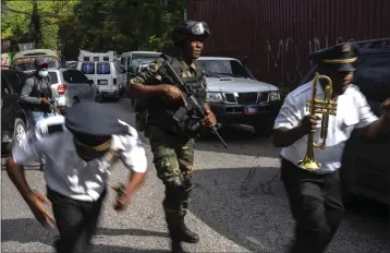  ?? RAMON ESPINOSA — THE ASSOCIATED PRESS ?? Police escort musicians arriving for the swearing-in ceremony of a transition­al council tasked with selecting a new prime minister and cabinet at the Prime Minister's office in Port-au-Prince, Haiti, Thursday.