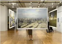  ?? AFP; Michele Nastasi ?? Far left, Saudi Arabia has lifted a ban on cinemas – part of a series of social reforms and blossoming of the arts; left, a photo of Reem Island in the Learning from Gulf Cities exhibition at NYUAD