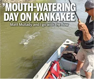  ?? DALE BOWMAN/SUN-TIMES ?? Matt Mullady works a smallmouth bass, caught on his hand-tied white streamer, to his boat on the Kankakee River.