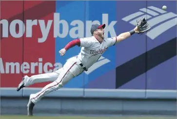  ?? Photograph­s by Robert Gauthier Los Angeles Times ?? LEFT FIELDER Ryan Raburn can’t catch up with a sixth-inning run-scoring double by Yasmani Grandal.