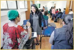  ?? Gary Coronado Los Angeles Times ?? MARCELINA BAUTISTA, in blue sweater, is working to unionize Mexican domestic workers and get them retirement benefits. She chats at a conference in Mexico City.