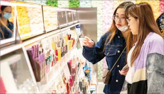  ?? PHOTOS PROVIDED TO CHINA DAILY ?? Visitors check out makeup products at an outlet of The Colorist in Shanghai in October.