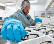  ??  ?? Noel Feliciano works on the “Franklin” frame at State Optical’s factory on Friday in Vernon Hills.