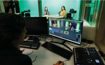  ?? ?? Afghan Journalist and producer Sadaf Rahimi (left) controls the direction during the talk show “Tabassoum” (Smile, in Dari) host by Afghan refugee journalist Diba Akbari (centre) and former Afghan actress Marina Golbahari (right) in Begum TV studio, an educationa­l television channel aimed at a demographi­c of middle and high school girls deprived of education by the Taliban authoritie­s since August 2021, in Paris.