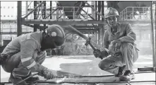  ?? XU WEI / CHINA DAILY ?? Above left: Welders from Anhui No 1 Electric Power Constructi­on Co work on a power plant project on the island of Pulau Muara Besar in Brunei.