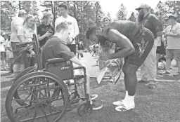  ?? ROB SCHUMACHER/REPUBLIC ?? Arizona State running back Eno Benjamin, right, signs his autograph for Creed Nelson of Queen Creek at Camp Tontozona on Saturday.