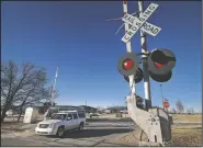  ?? (File Photo/NWA Democrat-Gazette/Ben Goff) ?? A vehicle crosses the railroad tracks that once bisected the Northwest Arkansas Community College campus in Bentonvill­e in 2014.