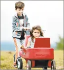  ??  ?? Amalia Zimmitti, 4, of Prospect, munches on an apple while family friend Dominick Duninzio, 6, of Long Island, N.Y., pushes her around.