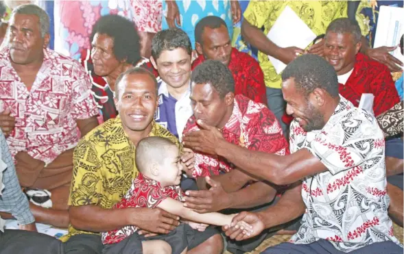  ?? Photo: Office of the Attorney-General ?? Attorney-General and Minister for Economy Aiyaz Sayed-Khaiyum (back, third from left) sits among Naivicula Vilagers; his son Idris Sayed-Khaiyum sits on Taniela Naibitakel­e’s lap while Vailato Cavasiga shakes his hand during the conclusion of the Early...