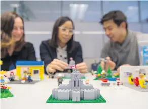  ?? RICHARD LAM/PNG ?? A replica of City Hall, constructe­d from Lego bricks, is displayed on a table. Amanda Gibbs, left, Jhenifer Pabillano and Lihwen Hsu of the city’s public engagement team use the Lego structures to spark conversati­ons with city residents.