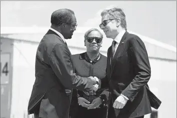  ?? Andrew Caballero-Reynolds Associated Press ?? U.S. AMBASSADOR to Jamaica N. Nick Perry, left, greets Secretary of State Antony J. Blinken on Monday in Kingston. The meeting was organized by a regional group pressing for a transition­al government in Haiti.