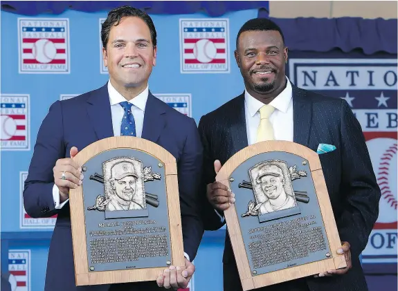  ?? — GETTY IMAGES ?? Mike Piazza, left, and Ken Griffey Jr. pose with their plaques after the Baseball Hall of Fame induction ceremony on Sunday in Cooperstow­n, New York. Griffey, who spent most of his career with Seattle, said he’s ‘damn proud’ to be a Mariner.