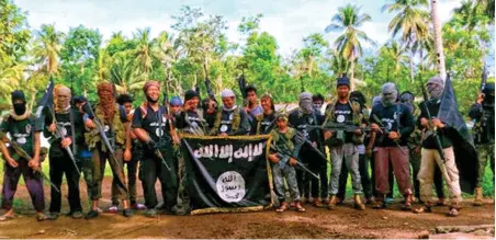  ??  ?? Members of the Philippine jihadist group pose for propaganda photo in this screen shot taken from the website of the Islamic State.