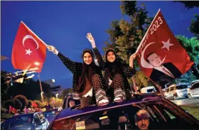  ?? YASIN AKGUL / AGENCE FRANCE-PRESSE ?? People wave flags outside the Justice and Developmen­t Party headquarte­rs in Istanbul, on Sunday, during the Turkish presidenti­al and parliament­ary elections. He Wenping,