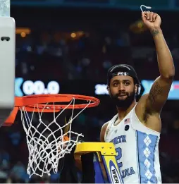  ?? (Reuters) ?? NORTH CAROLINA guard Joel Berry II – who was named the Final Four’s most outstandin­g player – cuts a piece of the net after the Tar Heels beat the Gonzaga Bulldogs 71-65 in Monday night’s championsh­ip game of the 2017 NCAA Tournament at University of...