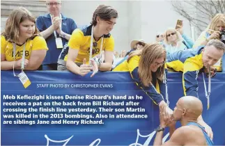  ?? STAFF PHOTO BY CHRISTOPHE­R EVANS ?? Meb Keflezighi kisses Denise Richard’s hand as he receives a pat on the back from Bill Richard after crossing the finish line yesterday. Their son Martin was killed in the 2013 bombings. Also in attendance are siblings Jane and Henry Richard.