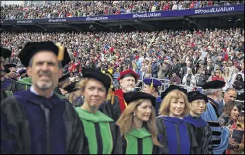  ?? ALEX WONG PHOTOS / GETTY IMAGES ?? Faculty, friends and families of graduates wait for the beginning of a commenceme­nt at Liberty University on Saturday in Lynchburg, Virginia.