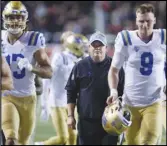  ?? Associated Press ?? UCLA coach Chip Kelly (center) runs off the field with the team at the end of the first half against Utah on Oct. 30 in Salt Lake City. The Bruins are playing for a bowl berth and Kelly’s job this week.