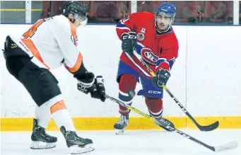  ?? JOE CSEH/SPECIAL TO POSTMEDIA NETWORK ?? Fort Erie Meteors' Cail Cirillo, left, defends Welland Junior Canadians' Drew Nesbitt in junior B hockey action Sunday night in Welland.