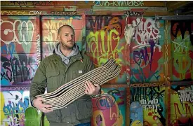  ?? PHOTO: DAVID WALKER/STUFF ?? Christchur­ch artist Wayne Walsh turns old skateboard­s into works of art, including one-off knives.