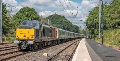  ?? THOMAS NICKLIN. ?? Rail Operations Group 37884 hauls 319425/428 through Longbridge on July 12, on their way for storage at Long Marston. The ‘37’ has been fitted with new coupling equipment, enabling it to haul electric multiple units without the need for translator...