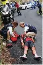  ?? Christophe Ena / Associated Press ?? Australia’s Richie Porte receives assistance after he crashed descending Mont du Chat pass in Stage 9. He broke his pelvis and collarbone.