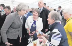  ??  ?? Elizabeth Warden of the Women’s Institute introduces Theresa May to Lesley Martin and Dorothy Robb at the Balmoral Show