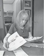  ?? BOB FARLEY/ FOR USA TODAY ?? Kathleen Immel Cross sorts through the day’s mail, including some bills, at her home in Pinson, Ala. After paying off more $ 21,000 in credit card debt in 2018, she’s starting to take on debt again due to medical procedures along with everyday necessitie­s.