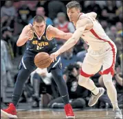  ?? Aaron Ontiveroz / The Denver Post ?? Isaiah Hartenstei­n, shown on the right as a member of the Rockets, steals the ball from the Nuggets’ Nikola Jokic on Nov. 20, 2019.