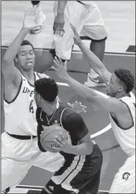  ?? Arkansas Democrat-Gazette/STEPHEN B. THORNTON ?? UALR defenders Mareik Isom (left) and Jermaine Ruttley (right) surround Texas State’s Emani Gant during the second half. UALR’s victory was its 11th in its past 12 games.