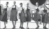  ?? AFP ?? Crew members of a Lufthansa Airbus dressed in typical Bavarian costume pose at the airfield of Franz-Josef-Strauss Airport in Munich, southern Germany.