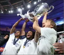  ?? Tribune News Service/getty Images ?? Rodrygo, Marcelo and Luka Modric of Real Madrid lift the UEFA Champions League trophy after a win against Liverpool during the UEFA Champions League final at Stade de France on May 28 in Paris.