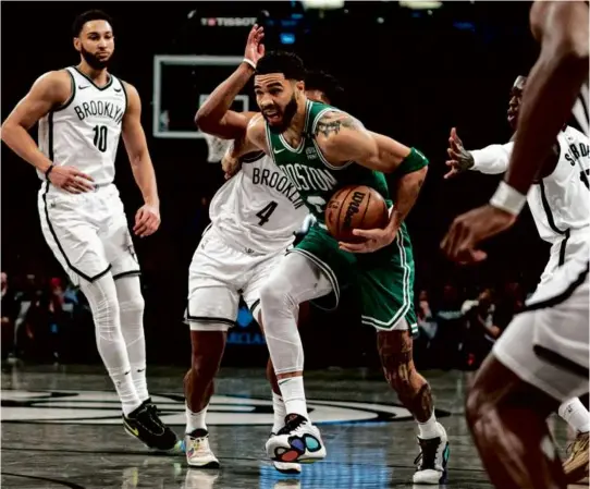  ?? PETER K. AFRIYIE/ASSOCIATED PRESS ?? Jayson Tatum, who shot 14 of 26 from the field and added 14 rebounds, blows past Nets guard Dennis Smith Jr. (4).
