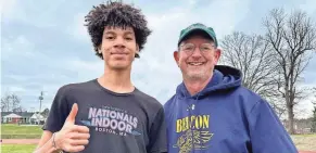  ?? STEPHEN HAYNES/POUGHKEEPS­IE JOURNAL ?? Beacon triple jump standout Damani DeLoatch poses with his coach, Jim Henry, during a practice outside the high school on Friday.