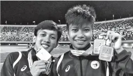  ?? MARIANNE L. SABERON-ABALAYAN ?? BACK-TO-BACK. Jhon Lloyd Cabalo and Jessel Lumapas pose with their men’s and women’s 400-meter gold medals Friday evening in the first day of BIMPNT-Eaga Friendship Games 2018 athletics competitio­n at the Hassanal Bolkiah National Sports Complex in Bandar Seri Begawan, Brunei.