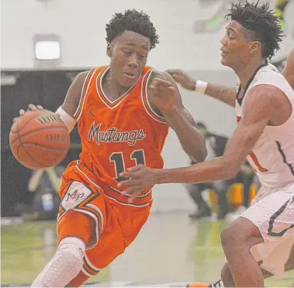  ?? | WORSOM ROBINSON/ FOR THE SUN- TIMES ?? Guard Ayo Dosunmu led the Mustangs with 21 points in their victory Tuesday against Bogan.