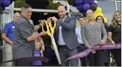  ?? JEFF GRITCHEN — STAFF PHOTOGRAPH­ER ?? James Innocenti, center, joins city officials as he cuts the ribbon at his Planet Fitness in Lake Forest on Tuesday.